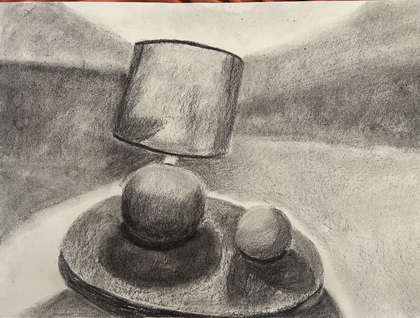 Charcoal still life of a glass tumbler and two spheres on a plate